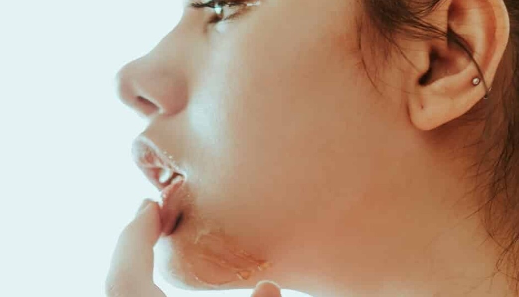 woman holding her lip