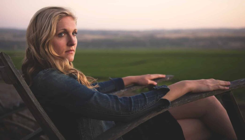 woman sitting on gray rocking armchair
