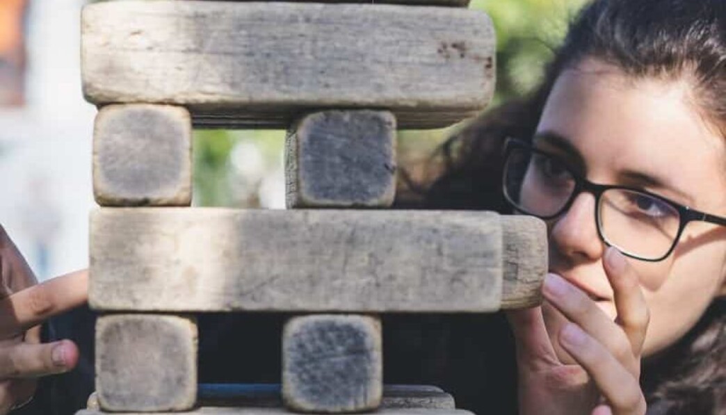 woman playing with wooden blocks