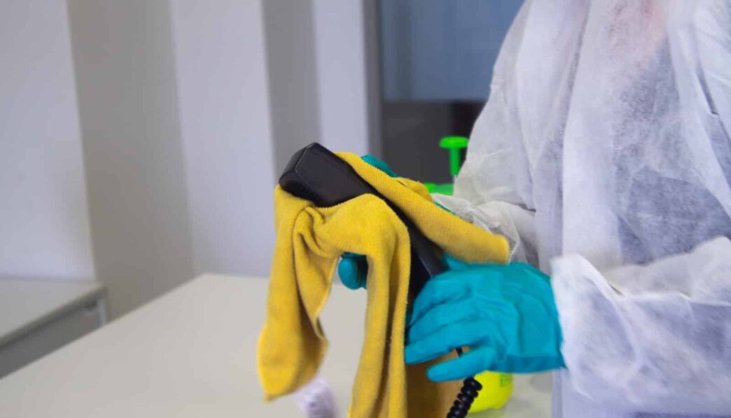 person in white robe holding black and yellow umbrella
