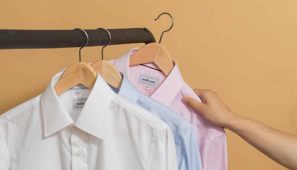 white button up shirt on brown clothes hanger