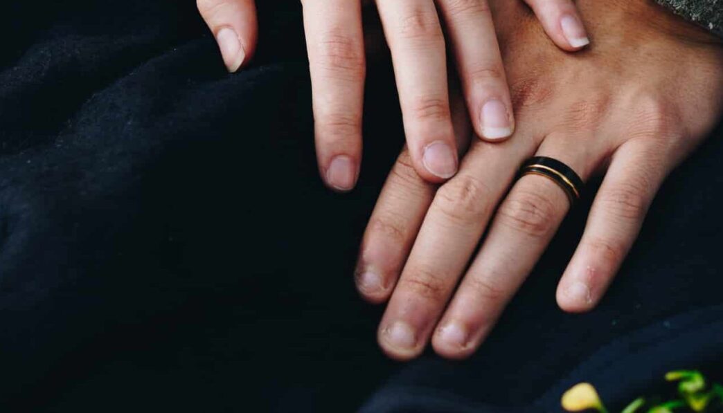woman holding hand of man