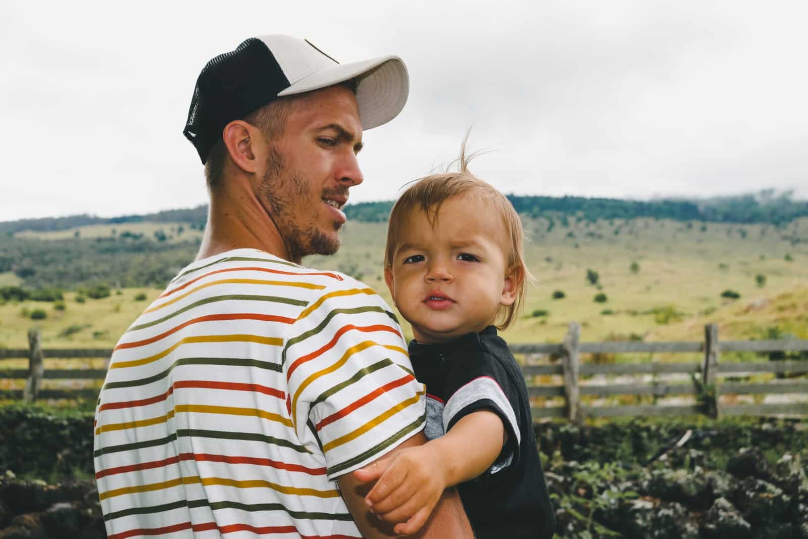 man carrying baby