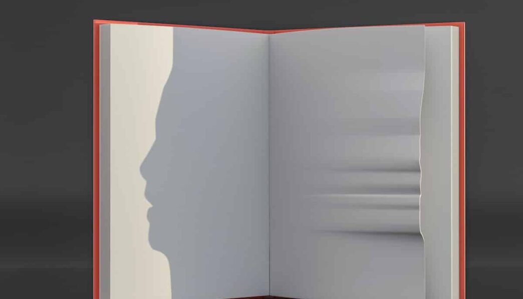 an open book with a shadow of a person