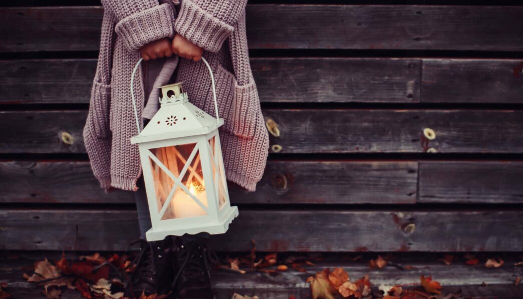 girl holding candle lantern