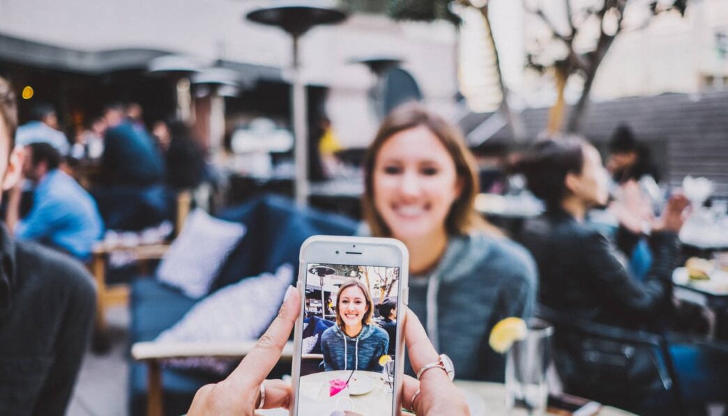 person taking photo of woman