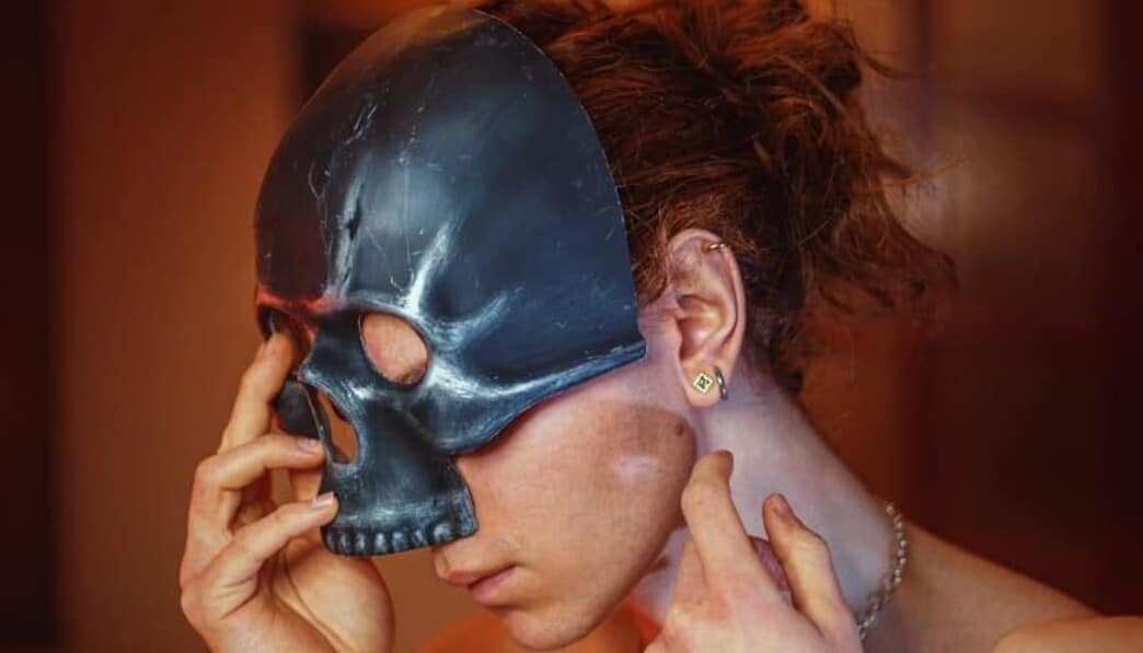 a woman with a skull mask covering her face