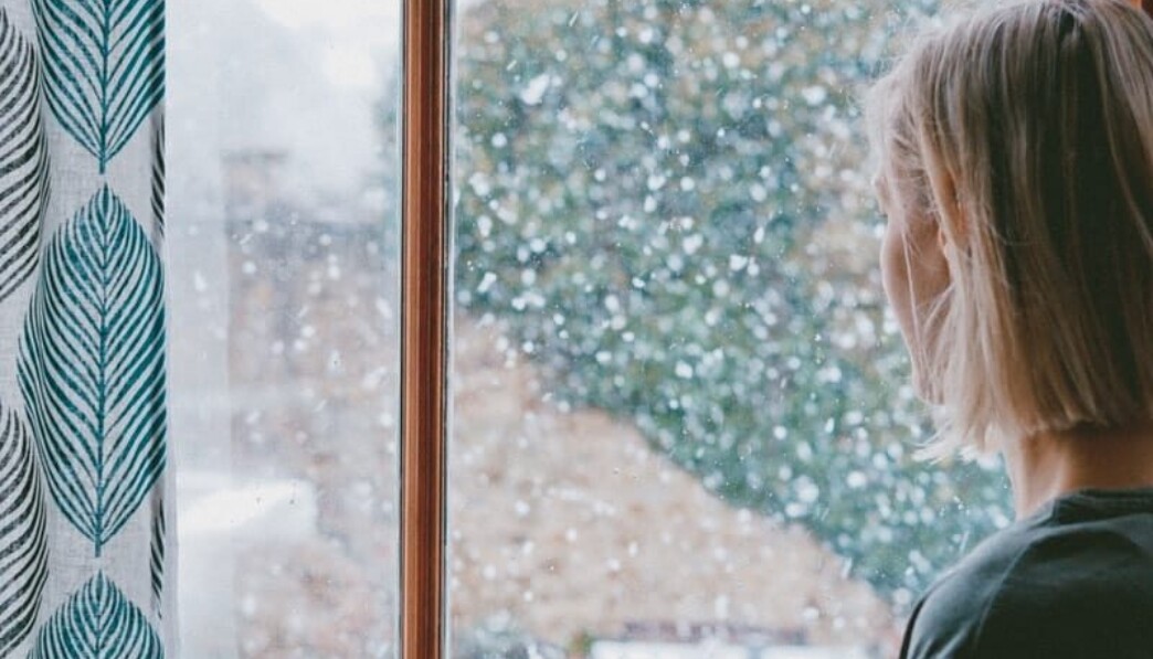 woman standing in front of clear glass window