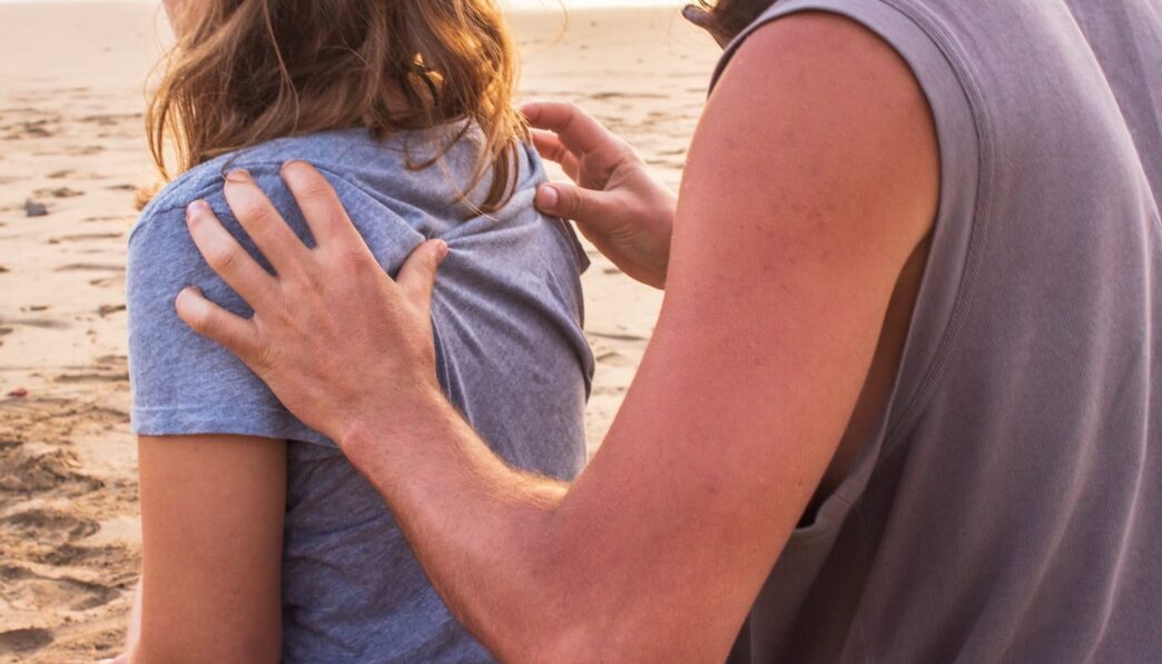 man massaging woman at the back