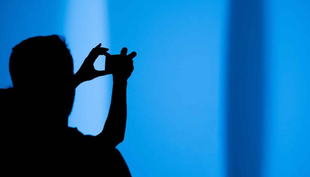 silhouette of a person using a gadget